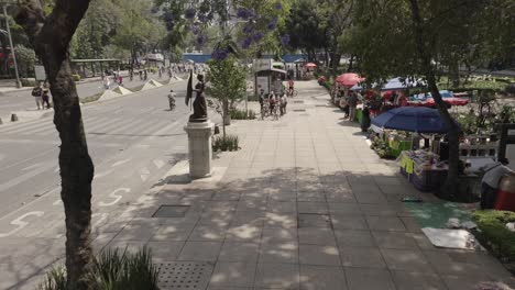 aerial wide angle dolly in of promenade next to street at la reforma at day
