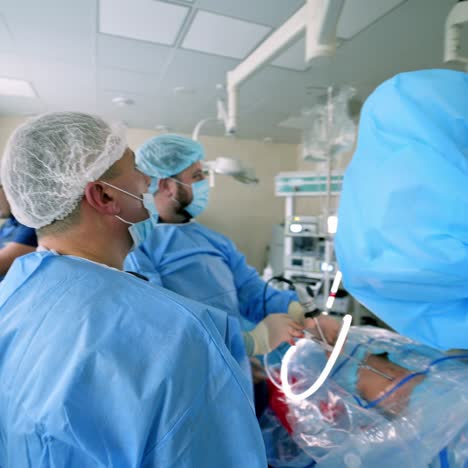 surgery with microscope. team of doctors in medical masks and uniform are performing an operation with modern equipment