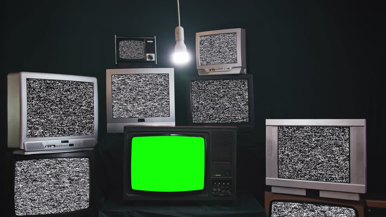 Old TV sets with static turned on Green screens. Lots of chromakey TVs in a dark room