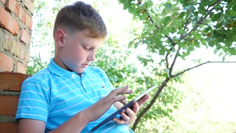 boy using a tablet outdoors