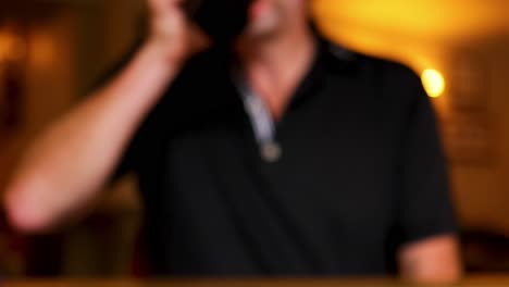 man drinking beer at a bar