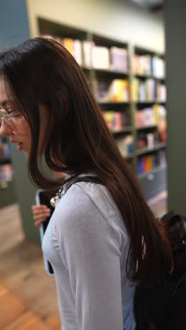 teenage girl in a library with a tablet