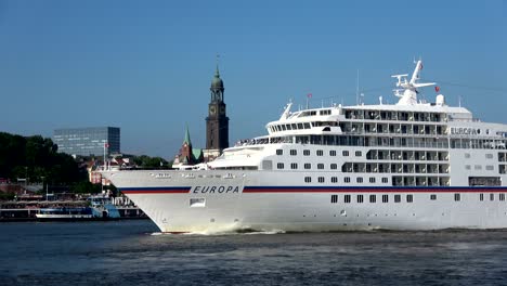 cruise liner in hamburg on departure, elbe and cityscape,