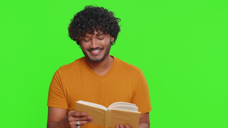 happy hindu man reading funny interesting fairytale story book leisure hobby education learning