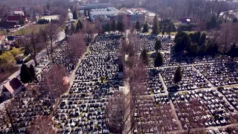 aerial shot of huge modern graveyard with shining graves on sunny morning