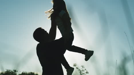 father and daughter piggyback ride at sunset