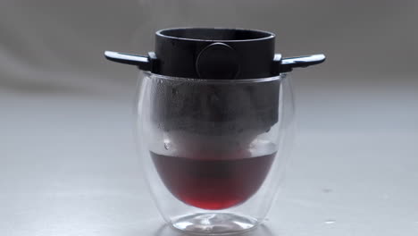 hot coffee drip in double wall glass with pour over filter