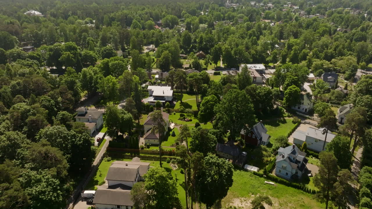 Aerial rising shot of a community of homes, sunny, summer day in Jurmala, Latvia