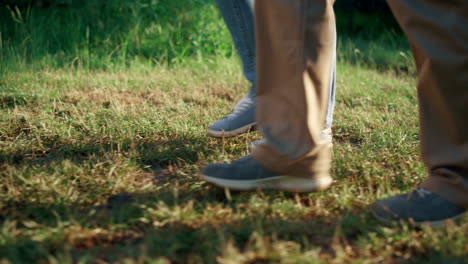 Two-farmers-legs-walking-garden-together.-Agronomists-going-in-tree-orchard.