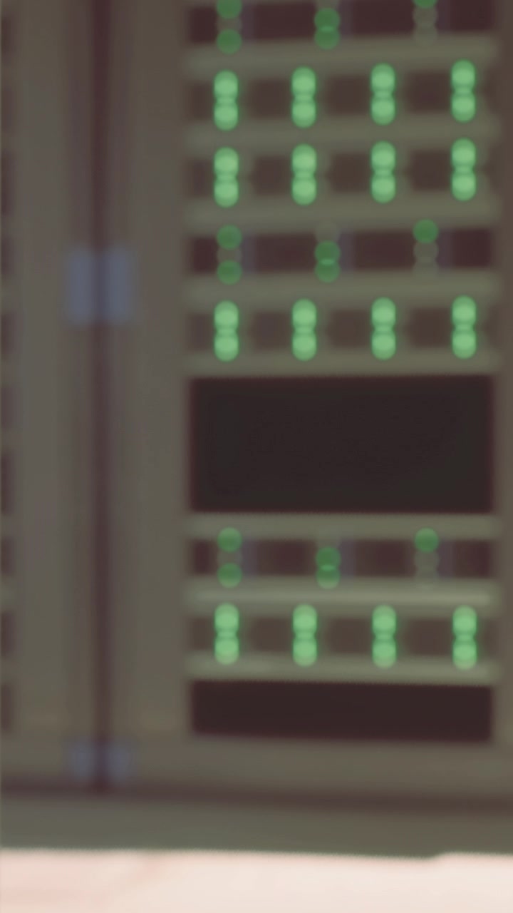 Lights blink on a server rack in a data center during the day