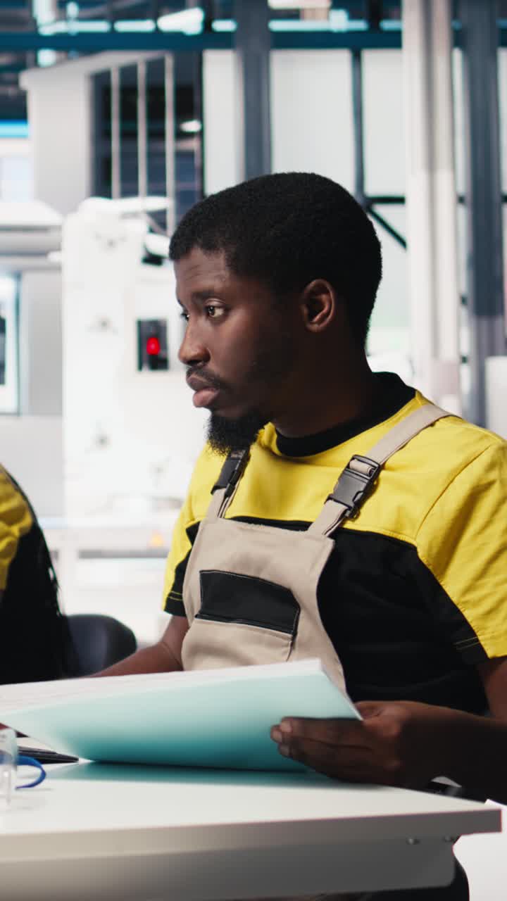 Vertical Video African american supervisor finetunes energy control systems on office PC