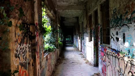 urban exploring - walking through a corridor with light shining in