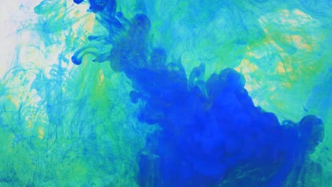 liquid abstractions, the dissolution of blue, yellow and green paint in water.