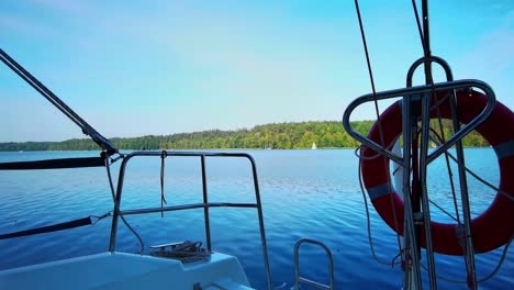 the front bow of a white sailing boat with blue sky and sea background