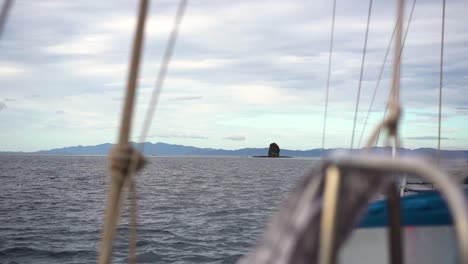 slow motion static shot from inside a sailboat while navigating in cloudy day