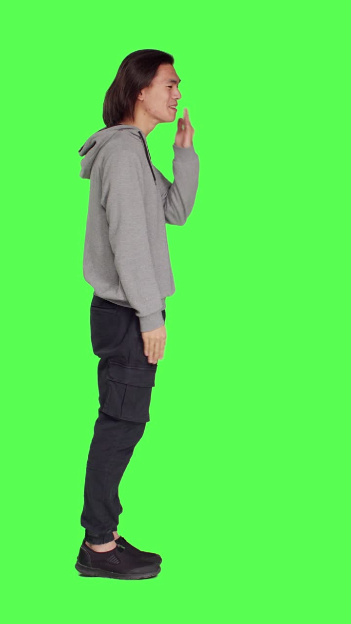 Profile of asian guy sending air kisses on camera