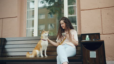woman and her dog on a bench