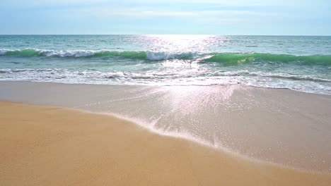 slow-motion of big waves hitting the beach and spreading out over the sand