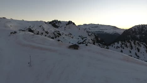 Chamrousse-mountains-summit-on-the-French-Alps-with-shelter-cabin,-Aerial-flyover-approach-shot