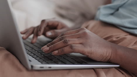 unrecognizable african-american woman working on laptop