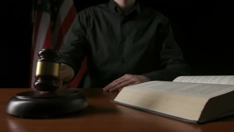 judge in courtroom with gavel and book