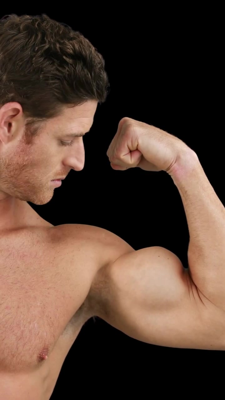 Vertical video: Male flexing bicep after pause while HUD panels overlaying and analyzing fitness