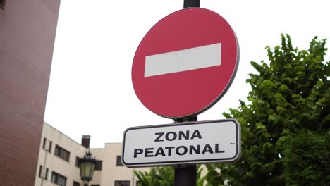 road sign pedestrian area with an inscription in spanish and entry prohibited