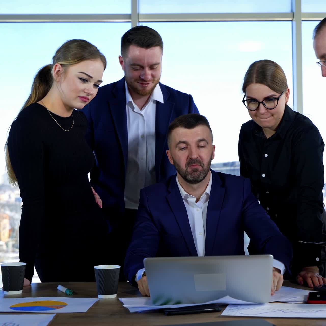 Group of business workers use a laptop. Positive entrepreneurs men and women speaking together about business together in office
