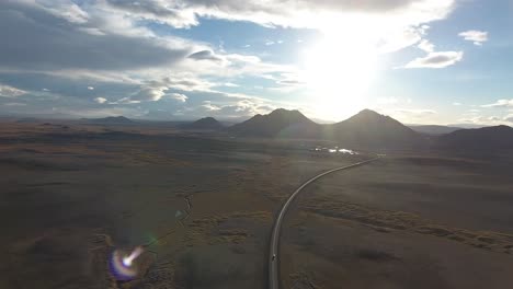 Icelandic-road-with-mountains-aerial-shot,-sunset-time