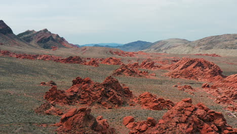 aerial view in front of red rocks in the deserts of nevada, partly sunny usa