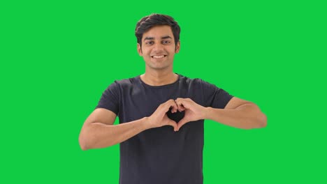 Happy-Indian-boy-making-heart-sign-Green-screen