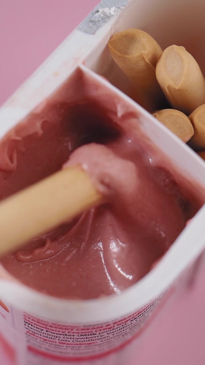 Dipping a Breadstick into Creamy Strawberry Dip