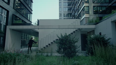 Business-man-in-suit-rushing-up-the-office-stairs-because-he-is-running-late