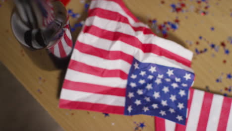 looking down on close up of napkins patterned with american stars and stripes flag at party celebrating 4th july independence day