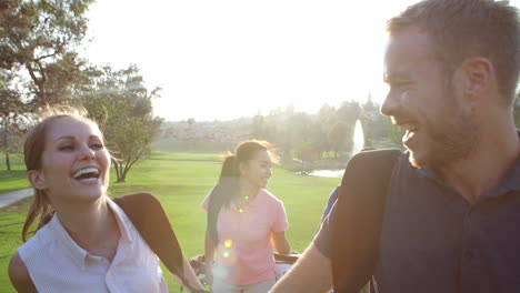 Slow-Motion-Shot-Of-Group-Of-Golfers-Walking-Along-Fairway