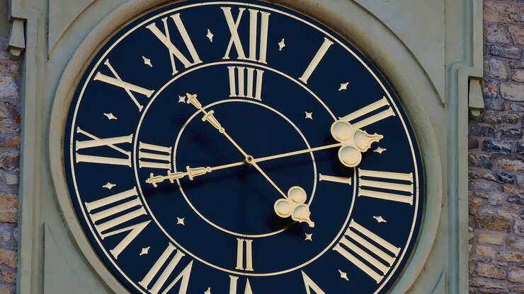 Prague clock tower dial with roman numerals in afternoon, hand moves