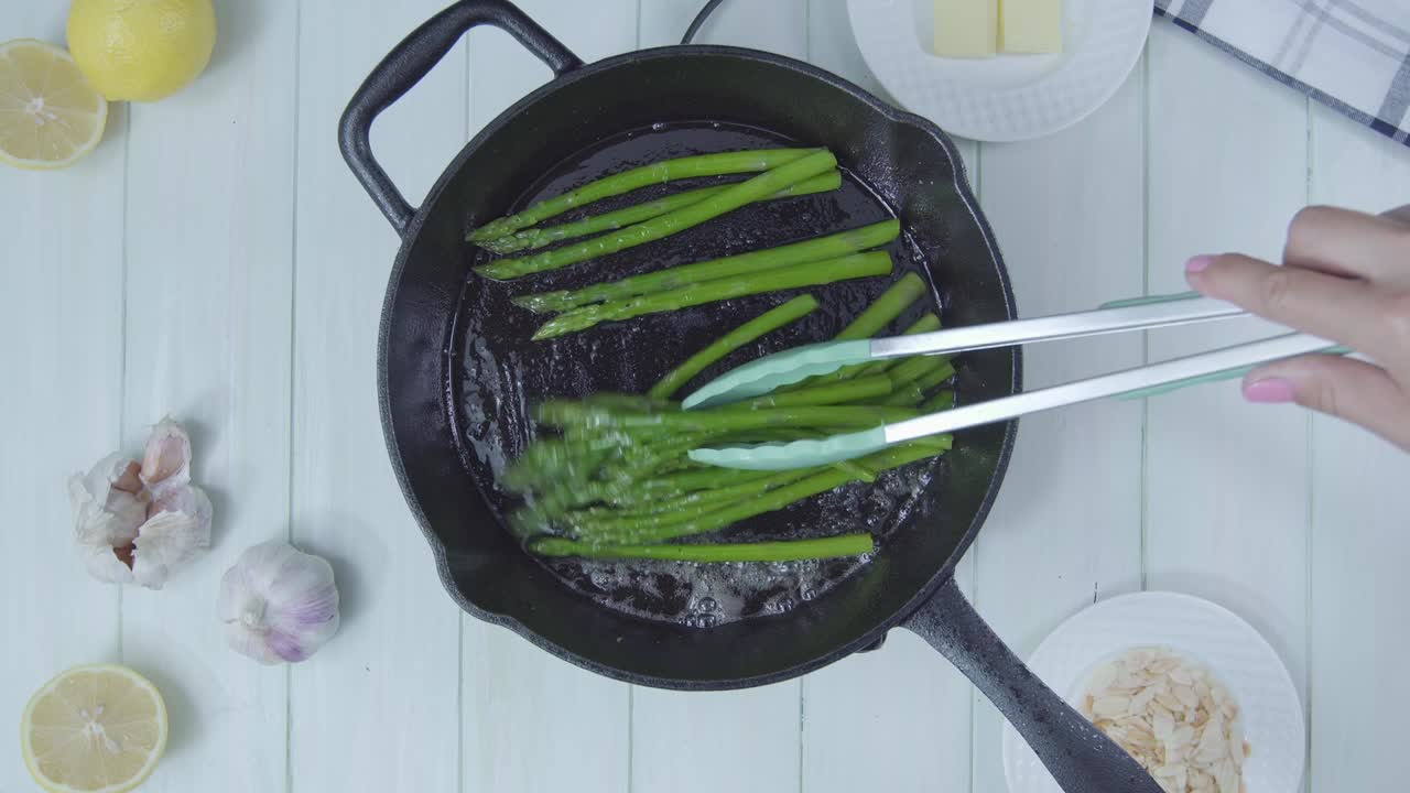 top down view of Green asparagus cocked in olive oil pan organic healthy vegan vegetarian plant based food diet