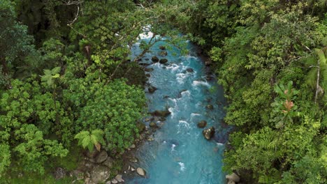 aerial drone shot of the famous rio celeste, a volcanic river in the jungle of costa rica with remarkably blue water