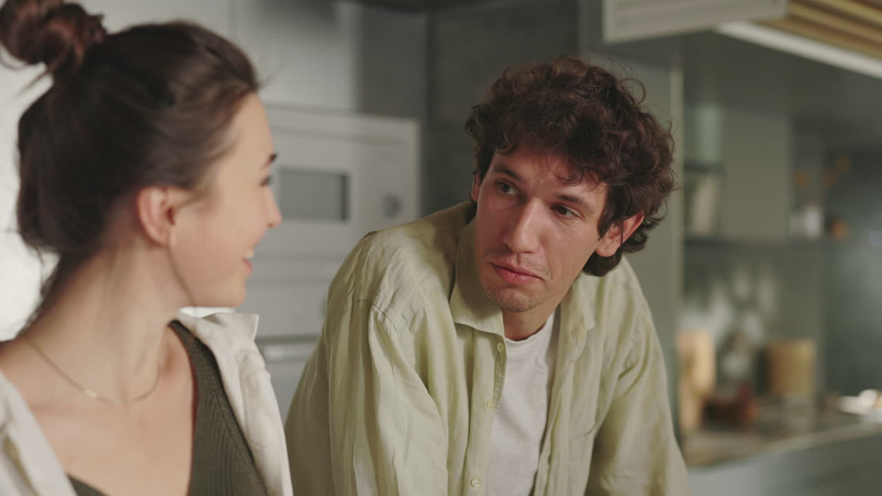 Couple's Playful Food Tasting Moment in the Kitchen