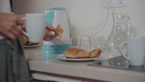 woman preparing and eating breakfast