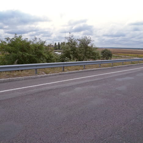luxury audi on the road on the background of nature. white electric car moving with blinking headlights on the highway.