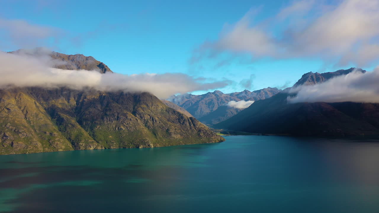 Picturesque aerial view flying over a lake in the scenic mountain landscape of New Zealand's South Island