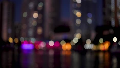 colorful city lights reflecting on water at night