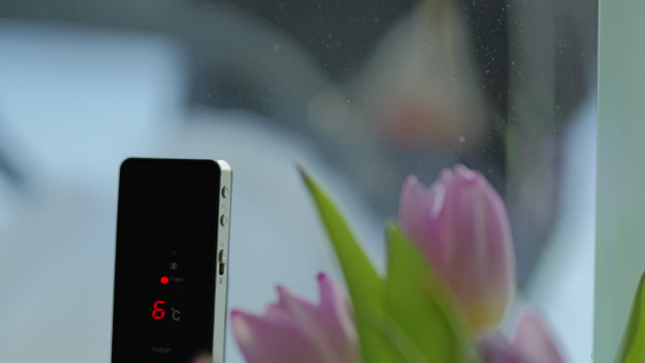 Baby sleeping in the stroller outside in cold weather. Rack focus to alarm