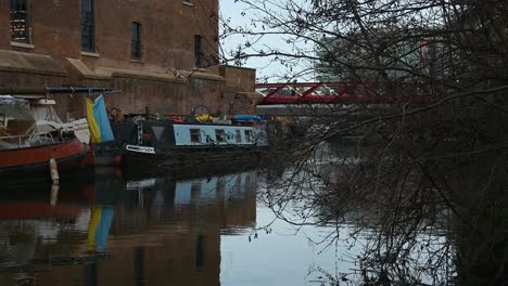 A-view-of-the-Ukrainian-Flag-above-a-Canal-boat-near-to-Kings-Cross-and-St-Pancras,-London,-United-Kingdom