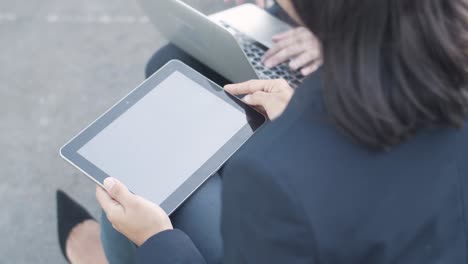 tablet and hands of business woman sitting near colleague