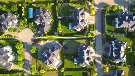 aerial view of residential houses neighborhood and apartment building complex at sunset