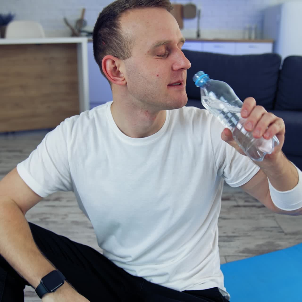 Man on floor at training. Young man practicing fitness with online training on laptop
