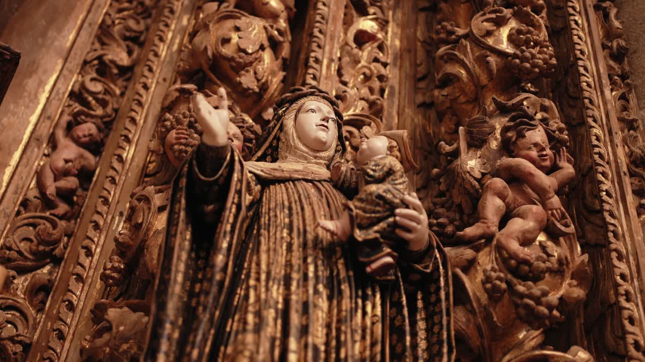 Intricate gilded religious statue surrounded by detailed cherubs and baroque carvings