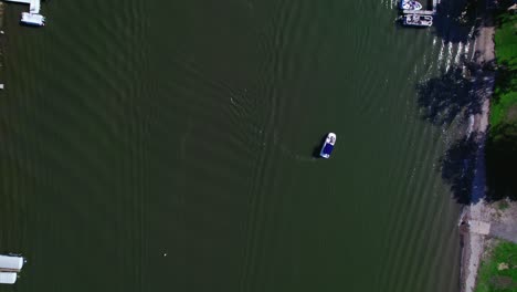 top view aerial drone shot following the river with boats and crossing bridges, yhat connect the riverbanks while cars drive away
